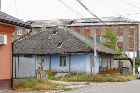 Broken roofs. Two sheets of slate were torn from roof of a small house and .. Stock Photos
