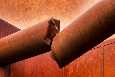 Broken off rust-coloured concrete column on a facade Stock Photos