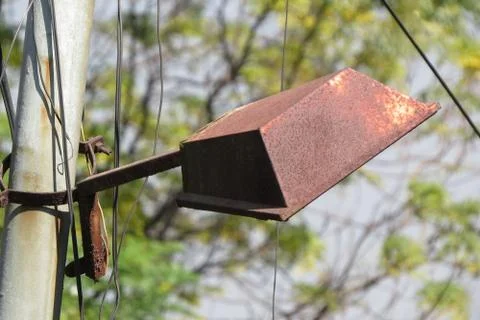 The broken Rusting street lamp on the side of road.Rusting lamp. Stock Photos