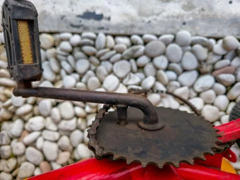 Broken rusty bicycle chain with red frame Stock Photos