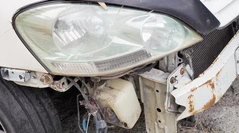 Broken rusty white car bumper. Car after an accident. Machine repair and parts Stock Photos