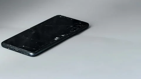 Broken screen protector for smartphone device, multiple cracks across screen Stock Footage 344095086