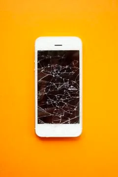 Broken screen of smartphone on the orange background Stock Photos