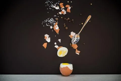 Broken shell, spices and spoon in artistic composition Stock Photos