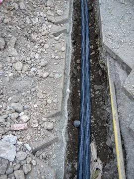 Broken sidewalk. Conducting the cable underground. Cable laying work. Commu.. Stock Photos