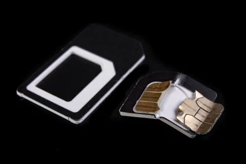 Broken sim card on the table. Destroyed data on the card with the chip. Stock Photos