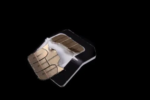 Broken sim card on the table. Destroyed data on the card with the chip. Stock Photos