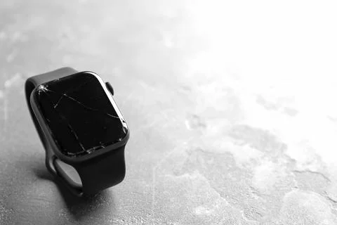 Broken smart watch on grey background, space for text. Repair service Stock Photos