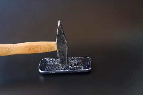 Broken Smartphone with hammer Stock Photos
