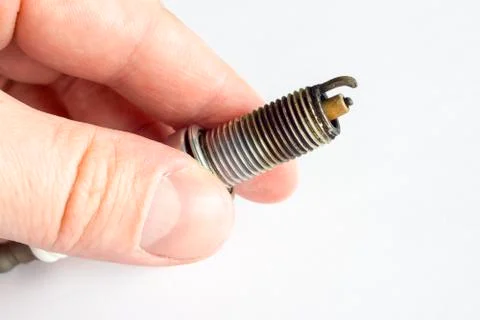 Broken spark plug in hand Stock-Fotos