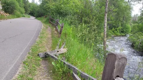Broken Split Rail Fence Along Bank of Forested River Trail Looking Upstream Stock-Footage 339512355
