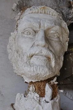Broken statue head ancient god Stock Photos
