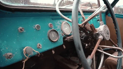 A broken steering wheel and a control board of an unusual antique car. Stock Footage 114326085