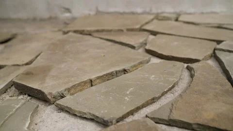 Broken stone tiles on ground with rough texture and natural earth tones Stock Footage 337934396