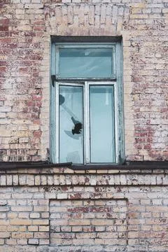 Broken stone window in an old brick house Stock Photos