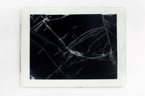 Broken tablet with cracked screen showing technology failure Photos
