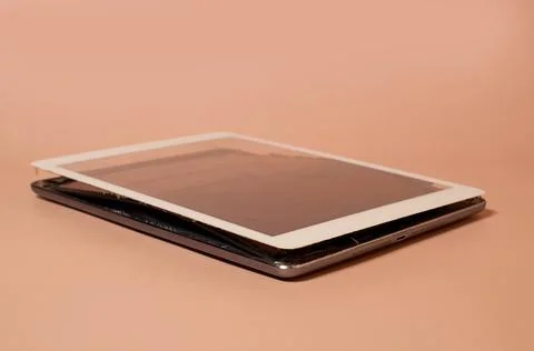 A broken tablet with a swollen battery and a dirty screen Stock Photos