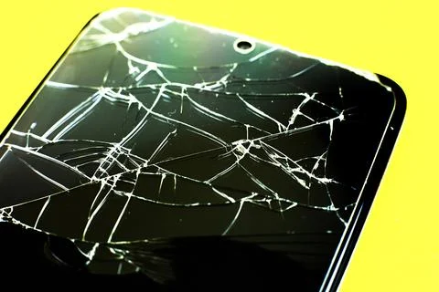 Broken tempered glass screen protector. Crashed smartphone. Close up. Фото