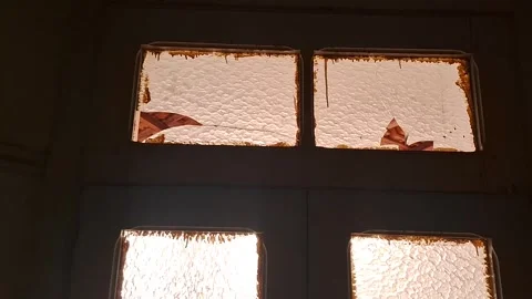 Broken textured glass window panels in dark room motion video footage Stock Footage 339505673