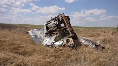 A broken tractor in the field, destroyed by the Russian enemy Stock-Footage 248534215