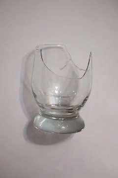 Broken transparent drinking glass in the kitchen Stock Photos