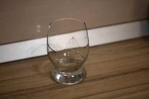 Broken transparent drinking glass in the kitchen Stock Photos