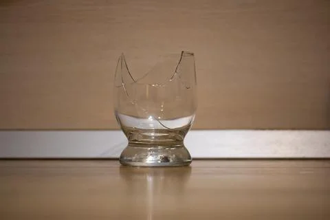 Broken transparent drinking glass in the kitchen Stock Photos