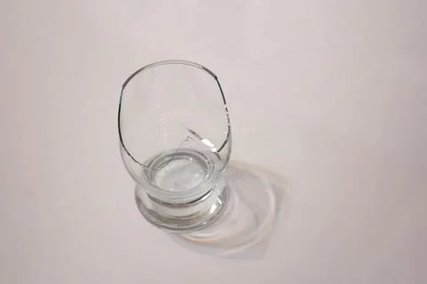 Broken transparent drinking glass in the kitchen Stock Photos