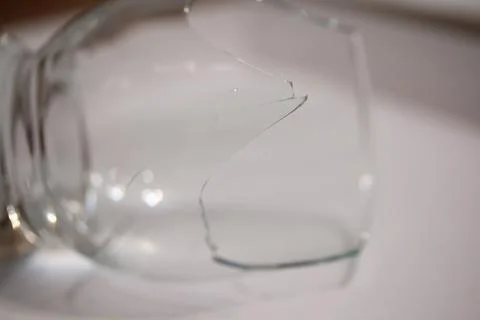 Broken transparent drinking glass in the kitchen Stock Photos