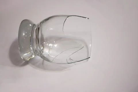Broken transparent drinking glass in the kitchen Stock Photos