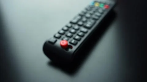 Broken TV remote on dark tabletop with missing power button and shallow depth Stock Footage 331111688