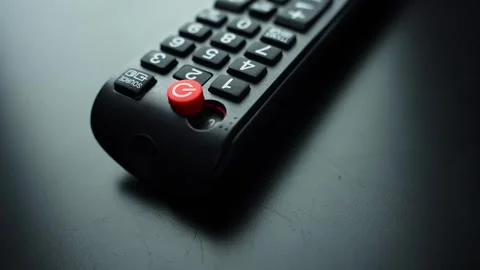 Broken TV remote with missing power button on a dark table, shot in macro with Stock Footage 329487927