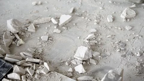 Broken TV screen buried under rubble and dust in damaged room Stock Photos