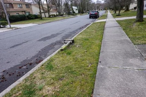 Broken vandalized mailbox post laying on the ground Stock Photos