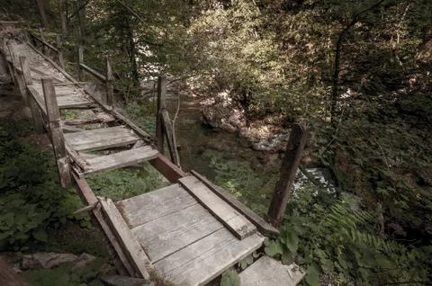 Broken walking bridge over the river Stock Photos
