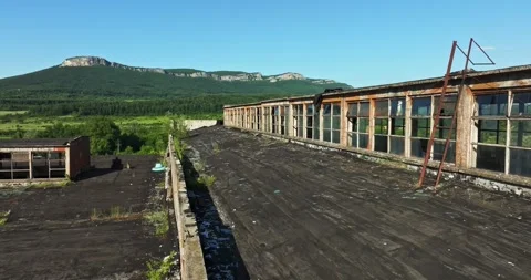 Broken In Warehouse Rooftop Glass Rust Debris Overlooking Vibrant Canyon Stock Footage 300485214