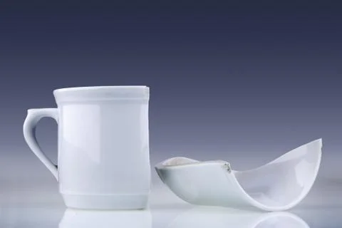 Broken white cup Stock Photos