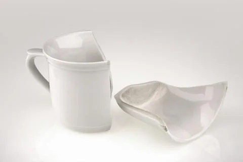 Broken white cup Stock Photos