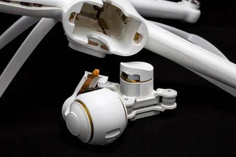 Broken white drone after a fall. On a black background. Damaged body and stab Foto stock