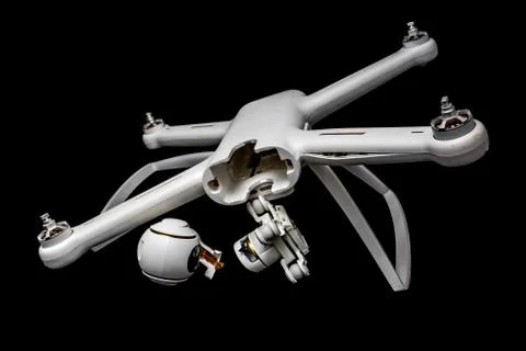 Broken white drone after a fall. Isolated on a black background. Damaged body Stock Photos