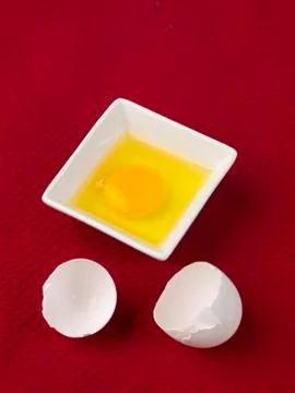 Broken white egg shell with yolk in bowl Stock Photos