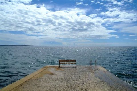 Broken wind clouds above the pier Stock Photos