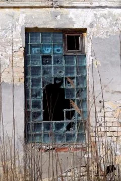 Broken window of an abandoned building Stock Photos