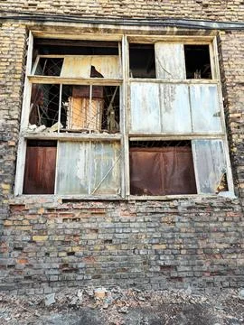 Broken window in an abandoned building. Stock Photos