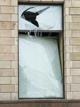 Broken window in abandoned building, shattered glass, dark brown border, be.. Stock Photos