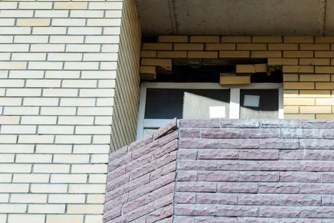 Broken window on an abandoned construction site after developer bankruptcy Stock Photos