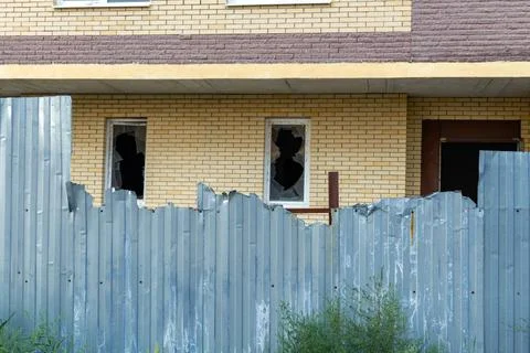 Broken window on an abandoned construction site after developer bankruptcy Stock Photos