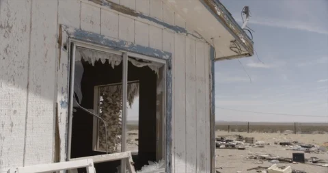 Broken Window and Yard of Junk at Dilapidated and Abandoned House Tilt. Down Stock Footage 89942320
