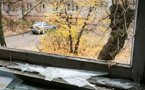 Broken window frame with shards on sill Stock Photos