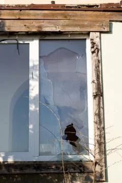 A broken window in an old abandoned building. Broken glass on the window site Fotos de archivo